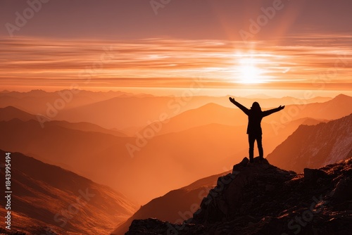 Sunset view from mountain peak with person celebrating at dusk