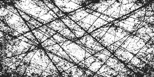 Barbed metal wire fence pattern against a winter sky and black tree branches