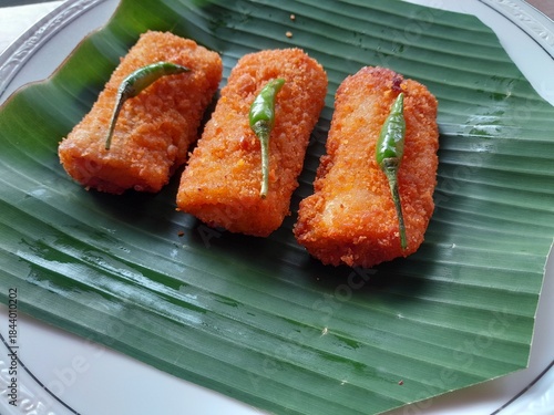 Three neatly arranged mayo risoles served on a banana leaf base