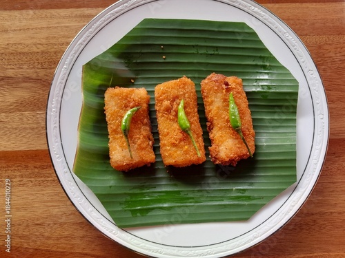 Three neatly arranged mayo risoles served on a banana leaf base