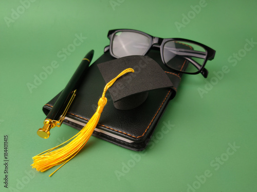 The image displays objects symbolizing academic achievement and education