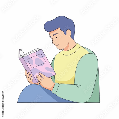 Young man engrossed in reading a book with a calm expression.