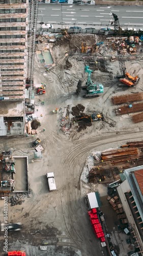 Construction cranes and excavators machinery working in development on construction site. hyperlapse timelapse time lapse Construction And Development Business. Elevated View construction site area