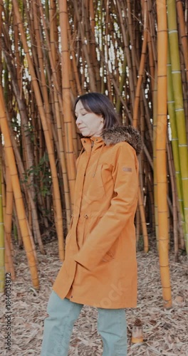 Woman walking in yellow bamboo grove
