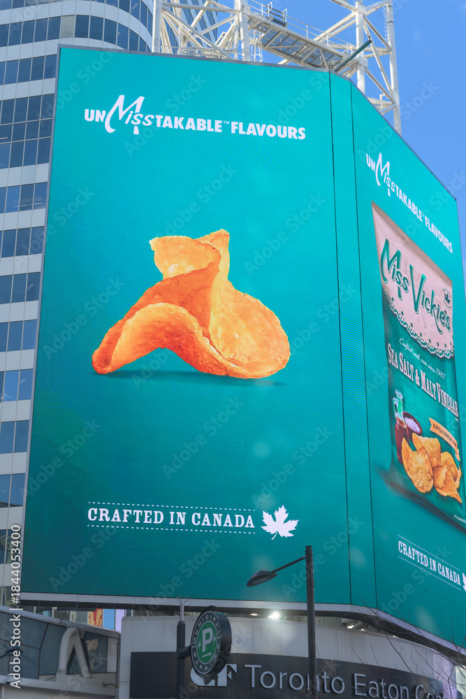 Naklejka premium electronic sign featuring advertisement for Miss Vickie’s Sea Salt & Malt Vinegar, a Canadian kettle-cooked potato chip brand (PepsiCo) near Sankofa Square, Toronto