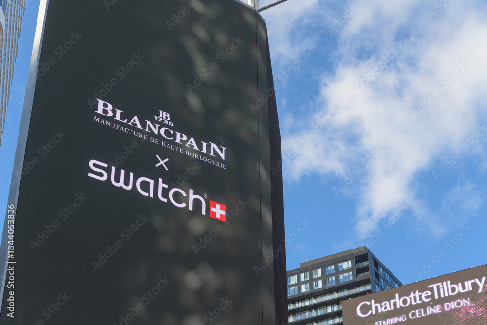 Naklejka premium close-up of digital advertisement featuring Swatch x Blancpain collaboration facing Sankofa Square, Toronto