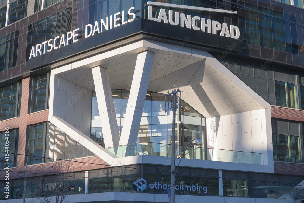 Fototapeta premium ghost signs of Artscape Daniels Launchpad still visible at 130 Queens Quay E, Toronto (Ethos Climbing, a rock climbing gym at 128 Queens Quay E)