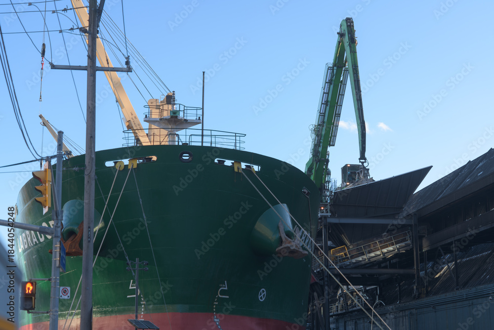 Naklejka premium view of Labrador, a bulk cargo carrier docked at Lower Jarvis Slip, next to Redpath Sugar Refinery, near 95 Queens Quay E, Toronto