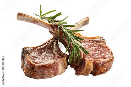 Two juicy lamb chops are crossed on a white background and garnished with a sprig of fresh rosemary. 