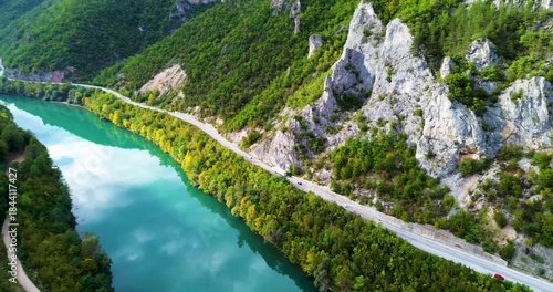 Aerial view of cars driving along a mountain canyon road