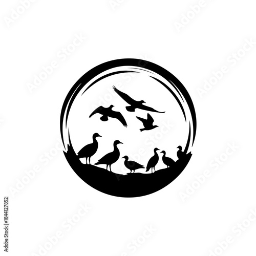 Circular logo design featuring silhouettes of flying and standing waterfowl isolated on transparent background