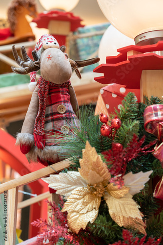 Lively holiday display featuring a bright lantern set among a lush Christmas wreath with red ribbons, gold ornaments, and pine accents. Perfect for festive home decor and seasonal celebrations.