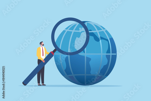 A businessman examines the world with a magnifying glass illustrating global research