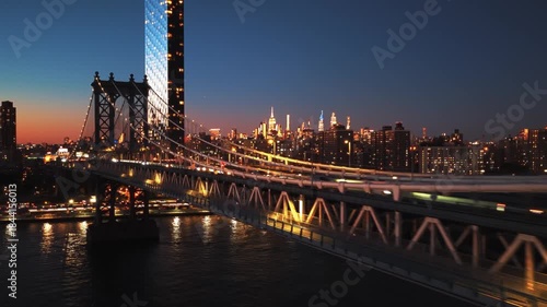 Detailed aerial view focusing on Midtown Manhattan skyscrapers, including the illuminated by the warm light of the golden hour