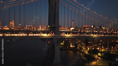 Detailed aerial view focusing on Midtown Manhattan skyscrapers, including the illuminated by the warm light of the golden hour