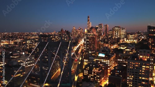 Aerial view of the Brooklyn Bridge entrance and ramp leading into Lower Manhattan, dominated by the towers of the Financial District and One World Trade Center