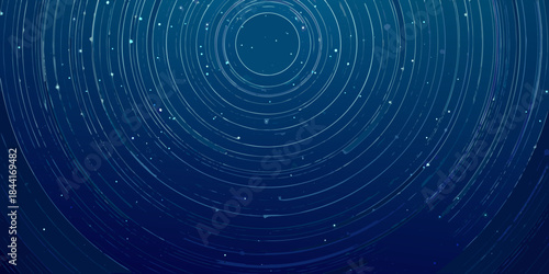 Abstract blue background with concentric circles and scattered sparkling particles