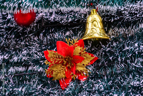 Close-up of a beautifully decorated ornament hanging on a artificial Christmas tree.