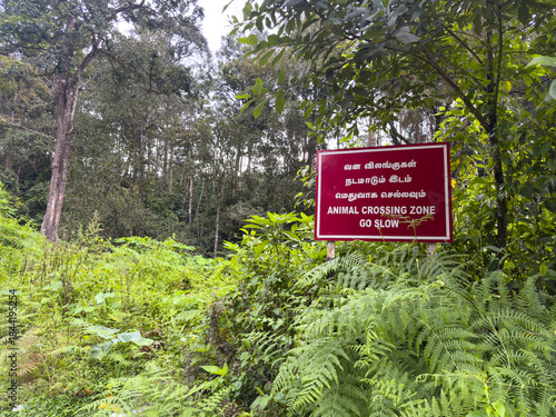 Signboard for the drivers to watch out for animal crossing, Valparai, Coimbatore district, Tamil Nadu. Translation: Vana Vizhangugal Nadamadum Idam in Tamil means Animal Crossing zone, go slow.