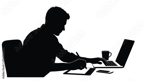 Silhouette of a man working on a laptop at a desk