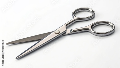 Shiny scissors with a polished finish positioned on a white background.