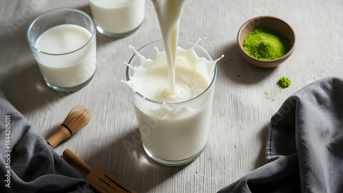 Wallpaper Mural Pouring Fresh Creamy Milk into a Glass with Splash and Droplets on a Light Table for Healthy Breakfast and Organic Dairy Product Marketing. Torontodigital.ca