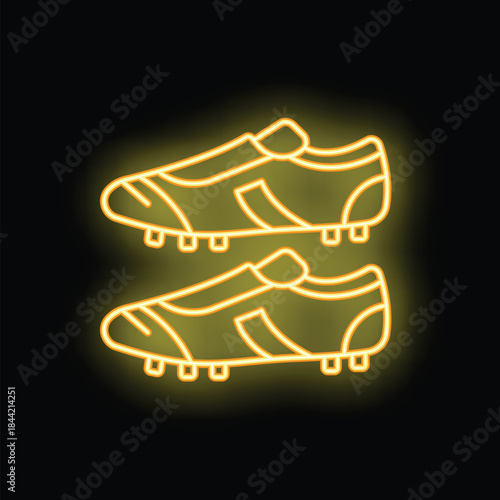 Pair of soccer cleats is depicted in a bright neon sign, illuminating the dark background