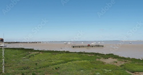 North beach of Fouras-les-Bains facing the Charente estuary and south of La Rochelle. The Fumée headland lighthouse, its jetty, carrelets and the marina