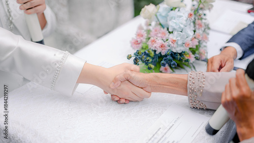 the groom and the marriage guardian are performing the marriage contract