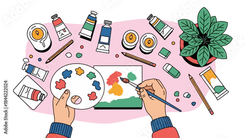 Artist's Hands Painting on Canvas with Art Supplies and Plant Overhead