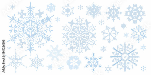 Collection of delicate pale blue snowflakes scattered across a white background
