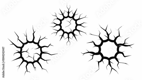 Three circular crack patterns on a white background resembling ice or broken glass