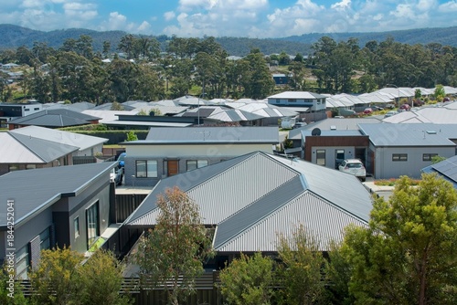 Overhead drone view of house roofs in a suburban housing development in Australia; illustrating the housing affordability crisis.