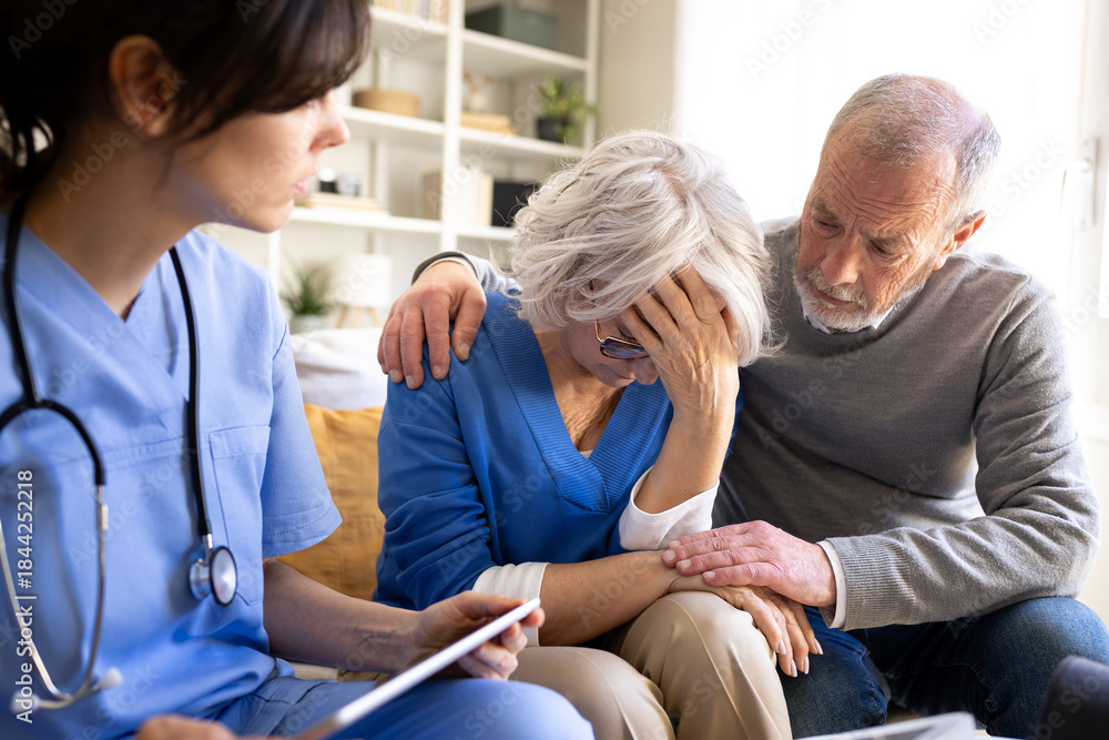 Fototapeta premium Doctor giving bad news to senior couple at home visit