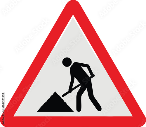 A triangular road sign depicting a worker with a shovel and a pile