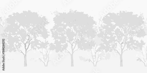 Silhouetted trees against a soft muted white background create a peaceful landscape