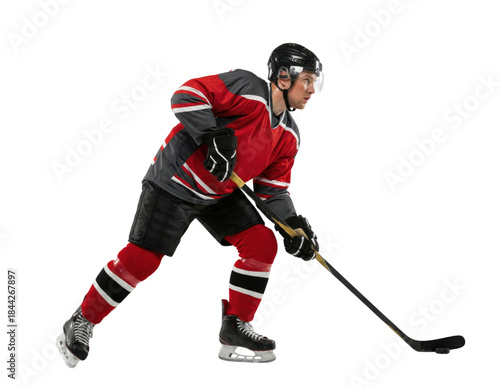 Ice hockey player in red uniform skating with stick isolated on white