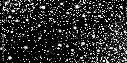 A black and white image depicting a field of scattered bright spots