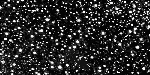 A field of scattered bright white specks against a dark black background