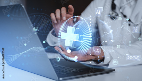 Futuristic healthcare technology concept with hologram interface over laptop and doctor background representing digital medical innovation concept.