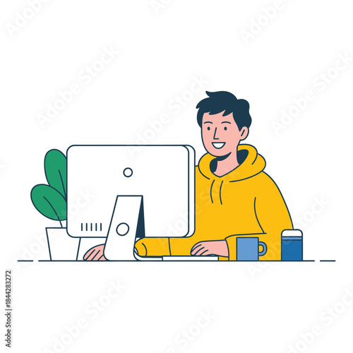 Young man cheerfully working on a computer with a relaxed atmosphere