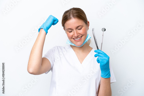 Dentist caucasian woman holding tools isolated on white background doing strong gesture