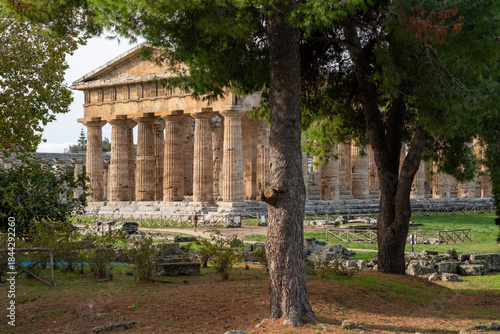Timeless beauty of Greek columns at Temple of Neptune under gray clouds