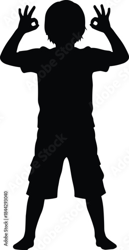 A cheerful boy silhouette, standing confident and making okay hand gestures with both hands; happy child outline wearing shorts and T-shirt expressing positivity and success.
