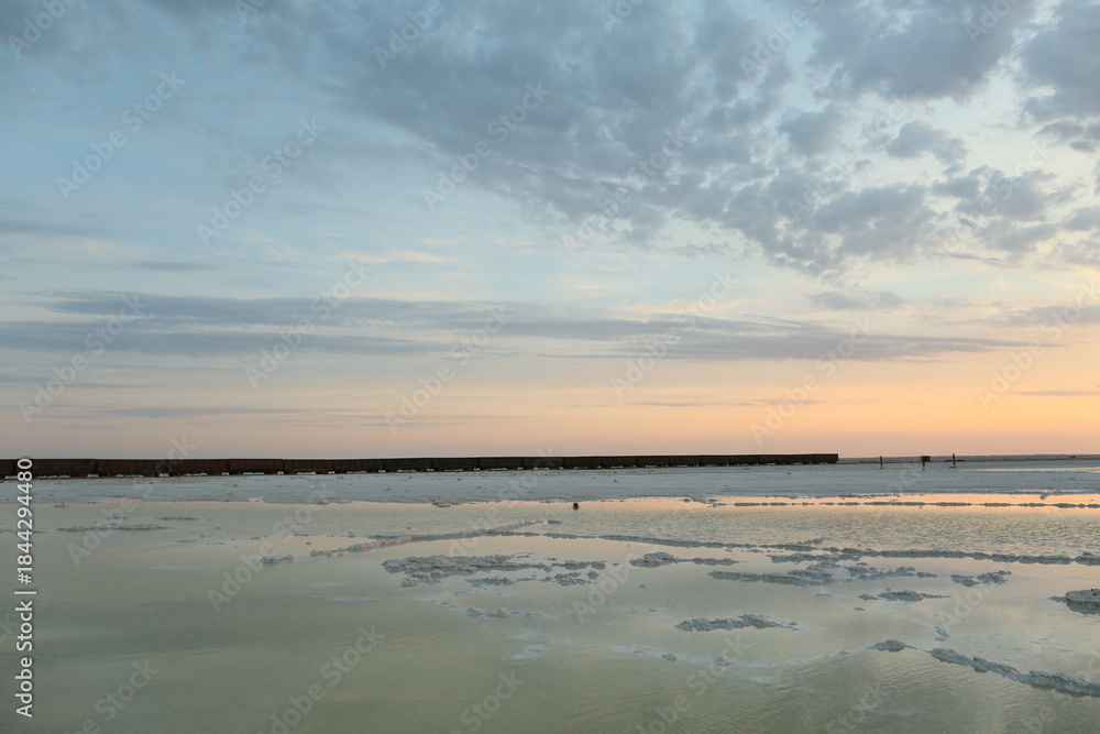 Obraz premium Landscape of salt lake Baskunchak at sunset in summer. View of Mount Bolshoe Bogdo. Astrakhan region. Russian landscape.
