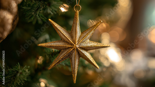 Epiphany star ornament. Golden star ornament hanging on Christmas tree with blurred lights  