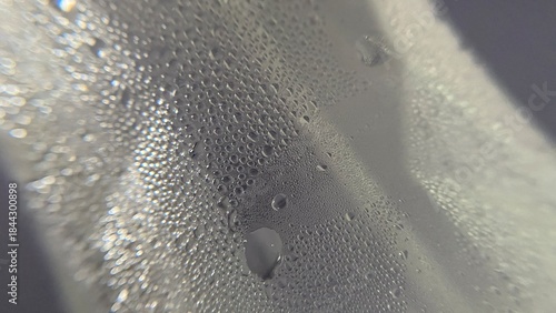 Abstract pattern of fresh, clean water drops and condensation on a wet glass surface