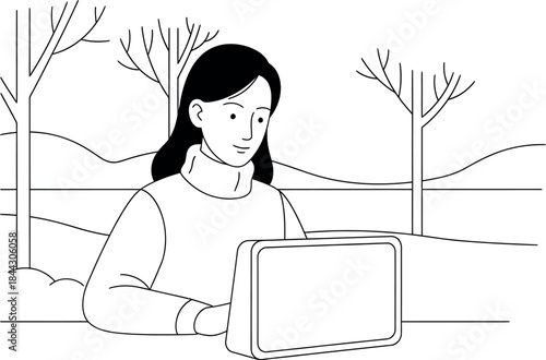 Woman working on laptop outdoors in winter