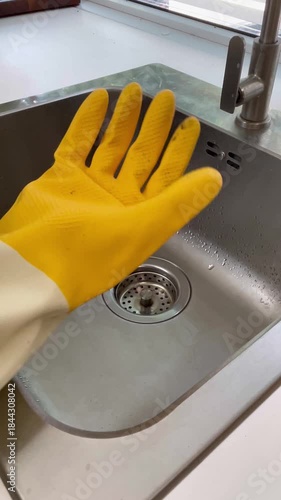 Wallpaper Mural Hand wearing rubber gloves squeezing a sponge for cleaning. Torontodigital.ca