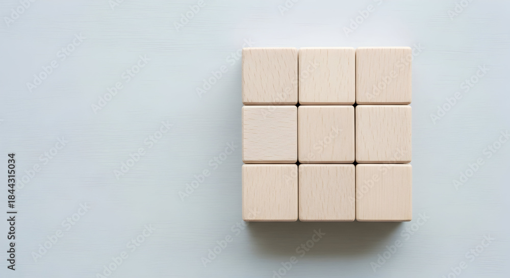 Obraz premium Elevate your project with this clean, minimal shot of nine wooden blocks, perfect for adding a touch of natural simplicity and organic feel to your design work.
